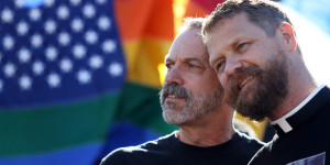 Michael Deschenes, left, and Cary Bass, who had church wedding and plan to become legally married, stand together at a celebration for the U. S. Supreme Court's rulings on Prop. 8 and DOMA in the Castro District in San Francisco, on Wednesday, June 26, 2013.  In a major victory for gay rights, the Supreme Court on Wednesday struck down a provision of a federal law denying federal benefits to married gay couples and cleared the way for the resumption of same-sex marriage in California. (AP Photo/Mathew Sumner)